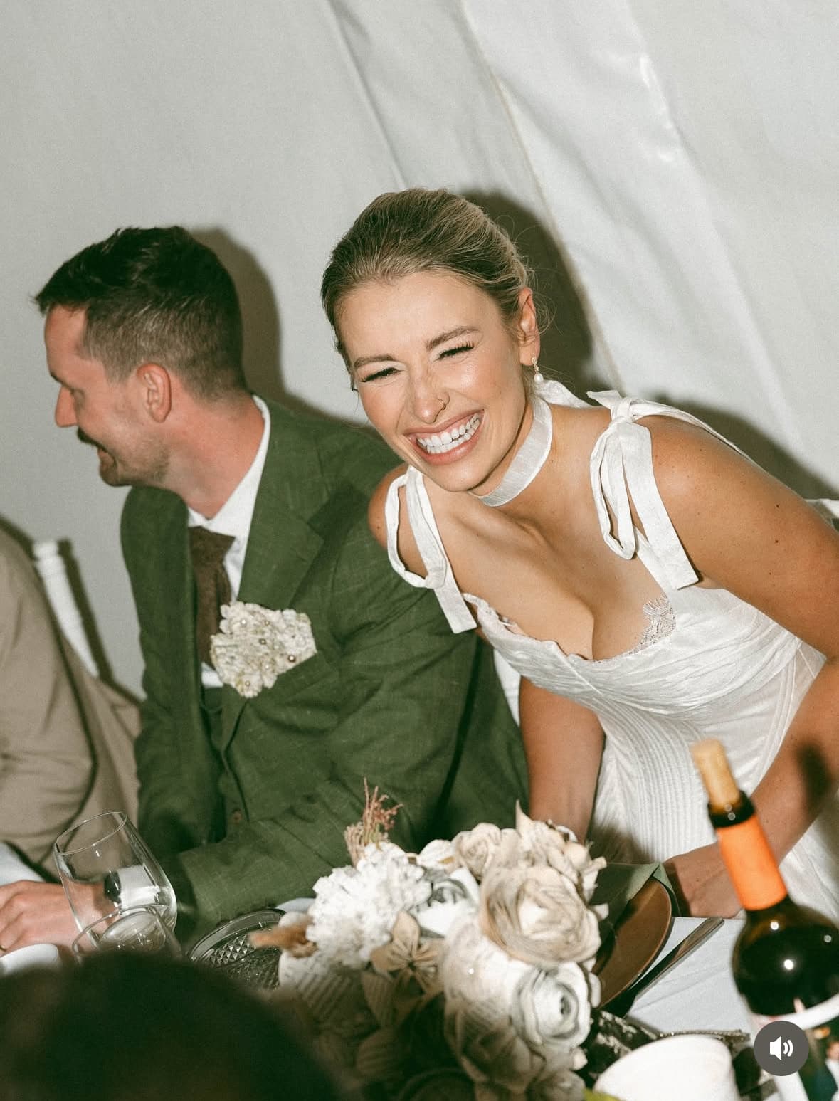 Bride laughing with groom at the wedding reception